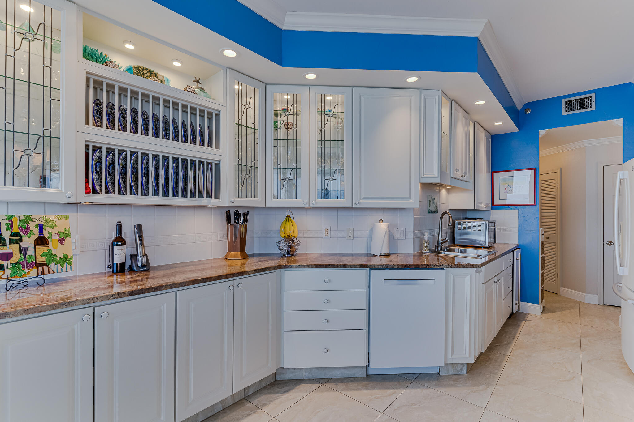 1096 Scenic Gulf Drive, Unit PH 1602 Miramar Beach, FL 32550 - Photo 21 of 80 a kitchen with stainless steel appliances granite countertop a sink and cabinets