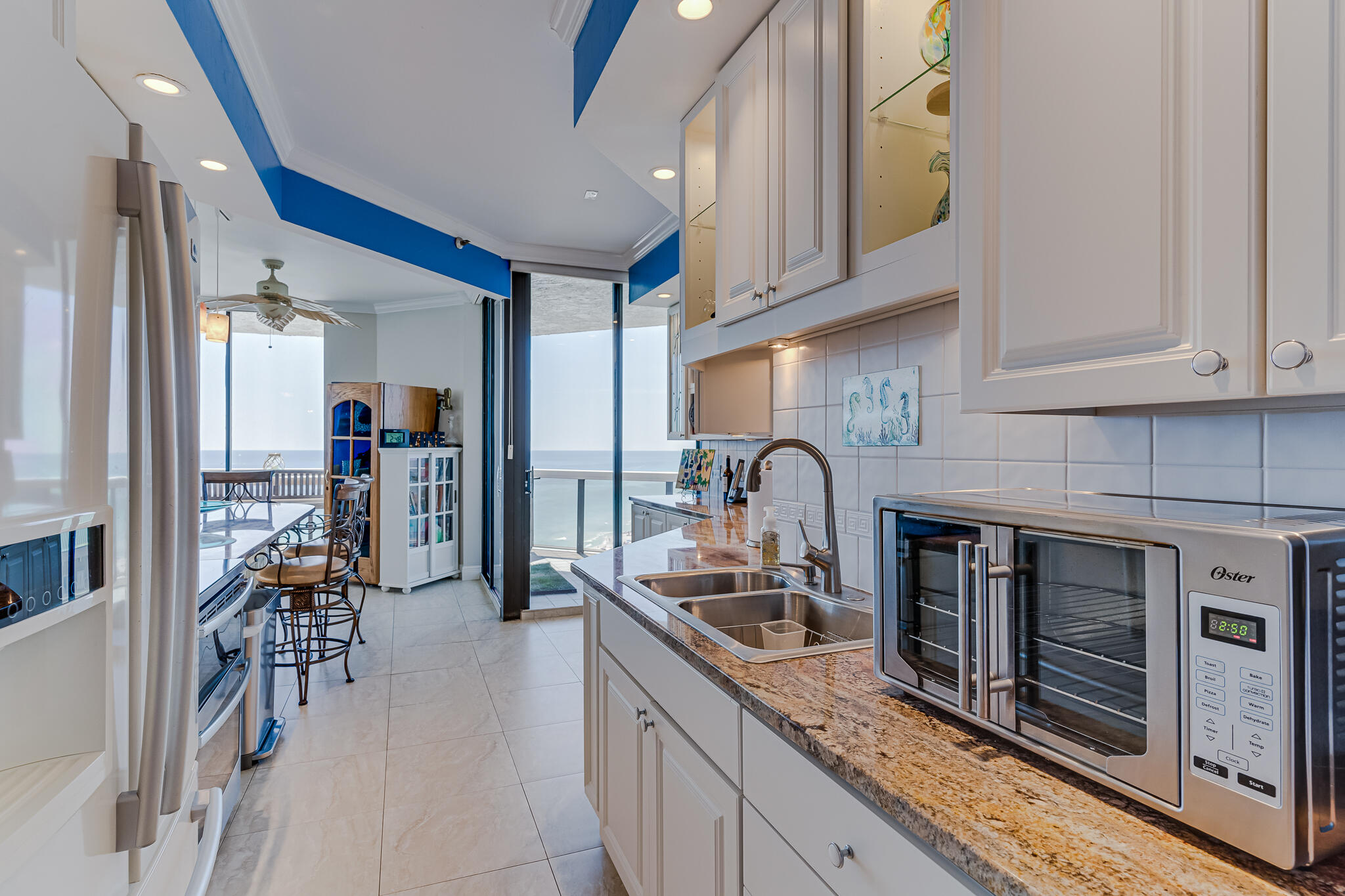 1096 Scenic Gulf Drive, Unit PH 1602 Miramar Beach, FL 32550 - Photo 22 of 80 a kitchen with stainless steel appliances granite countertop a stove a sink and a refrigerator