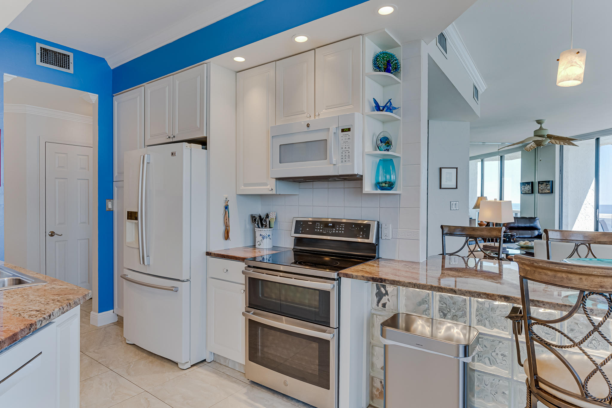 1096 Scenic Gulf Drive, Unit PH 1602 Miramar Beach, FL 32550 - Photo 23 of 80 a kitchen with stainless steel appliances a stove a sink and a refrigerator