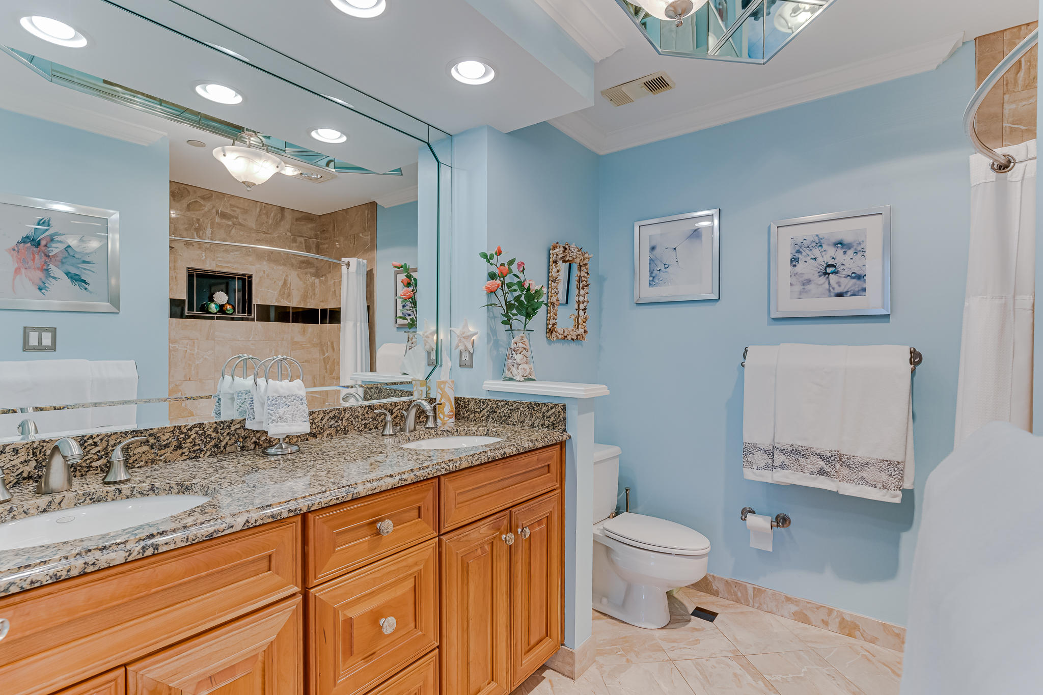 1096 Scenic Gulf Drive, Unit PH 1602 Miramar Beach, FL 32550 - Photo 35 of 80 a bathroom with a granite countertop sink a toilet and a mirror