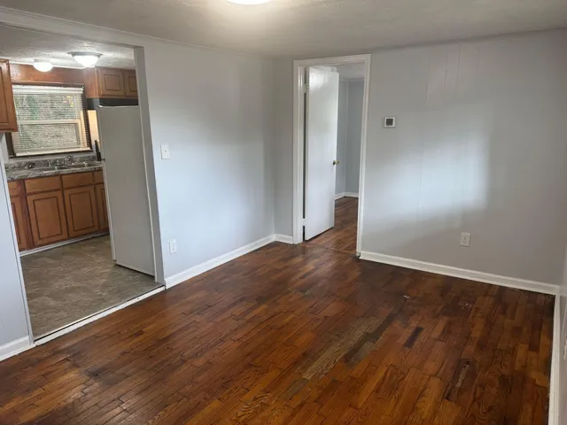 an empty room with wooden floor