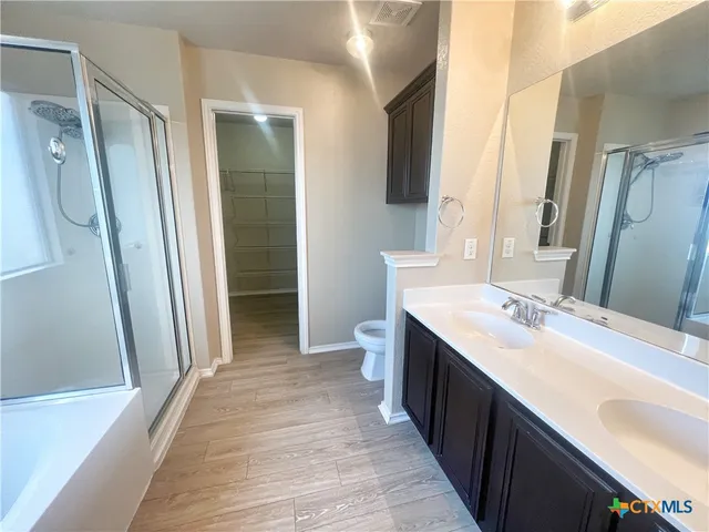 a bathroom with a double vanity sink and mirror