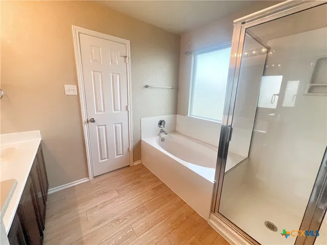 a bathroom with a bathtub and a shower