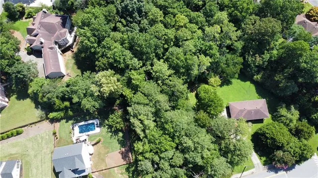 an aerial view of a house with a yard and lake view