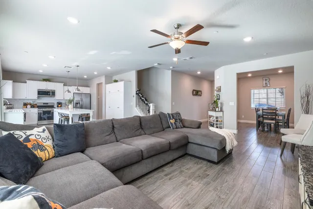 a view of a living room kitchen and a wooden floor