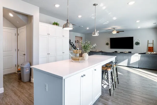 a room with stainless steel appliances kitchen island a large island in the center