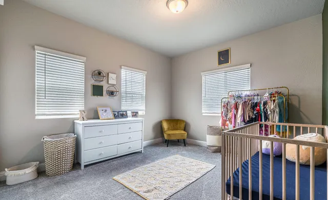 a bedroom with furniture and a window