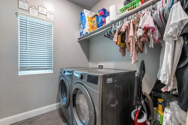 a spacious bedroom with a bed and a chandelier