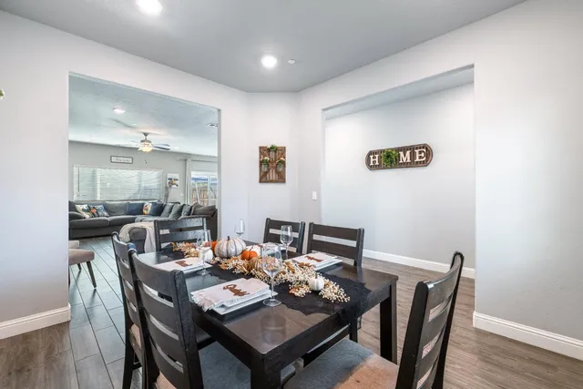 a dining room with furniture and wooden floor