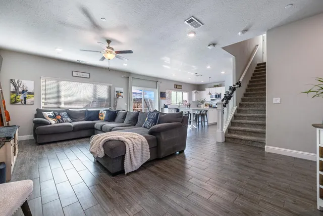 a living room with furniture and wooden floor