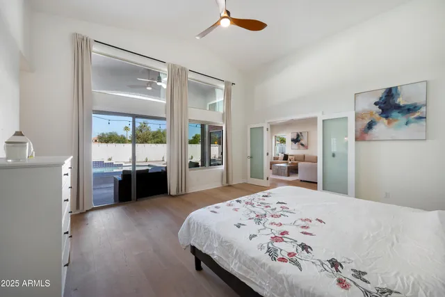 a bedroom with a bed and wooden floor