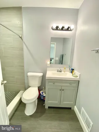 a bathroom with a sink toilet and a mirror