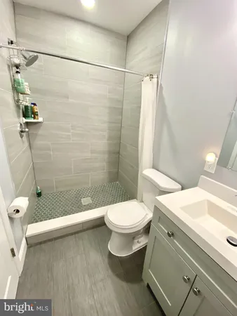 a bathroom with a toilet and a shower