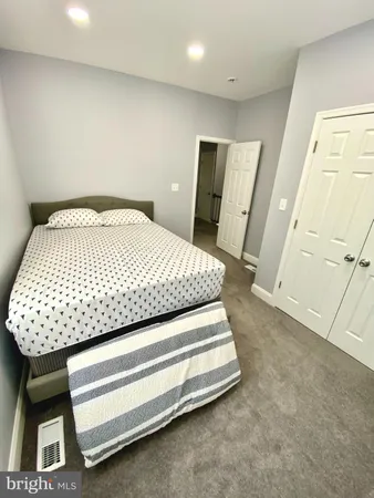 a bed sitting in a room next to a window