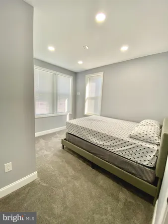 a spacious bedroom with a bed and a window