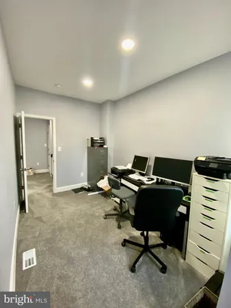 a living room with furniture and a air conditioner vent