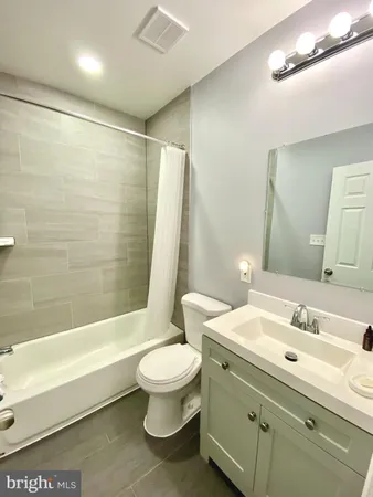 a bath tub sitting next to a shower