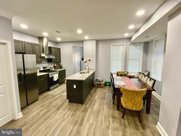 a large kitchen with lots of counter space and stainless steel appliances