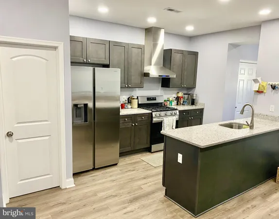 a kitchen with kitchen island a sink appliances and cabinets