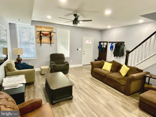 a living room with furniture or couch and a ceiling fan