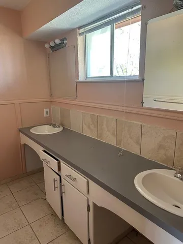 a bathroom with a sink and a window