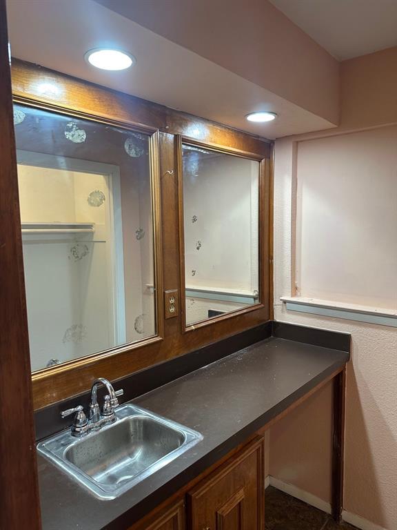 1905 Hard Rock Road Irving, TX 75061 - Photo 17 of 24 a bathroom with a sink and a mirror