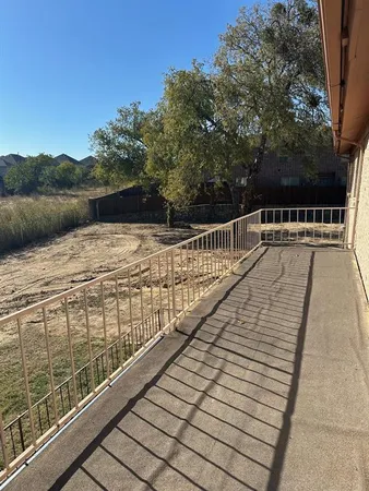 a view of balcony with wooden floor and fence