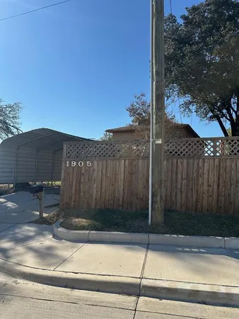 a backyard of a house with fountain table and chairs