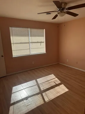 a view of a room with wooden floor and windows