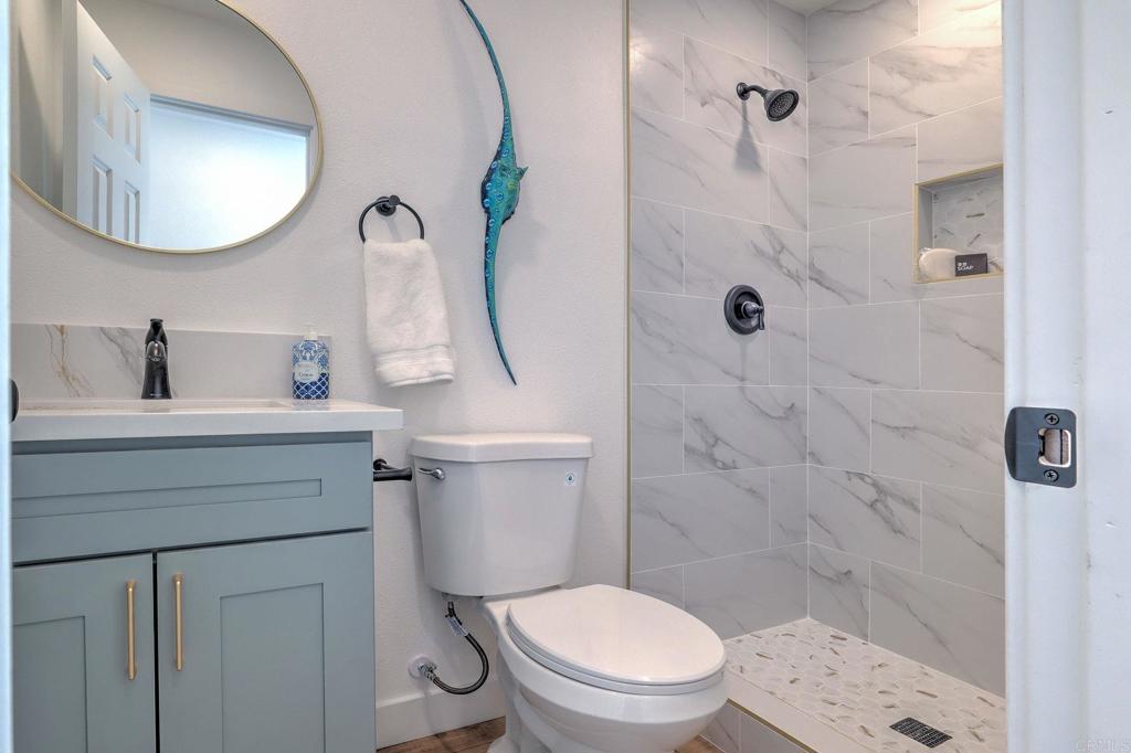 4205 Rene Drive San Diego, CA 92154 - Photo 19 of 29 a bathroom with a sink a toilet and shower