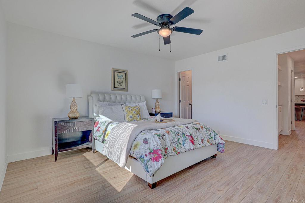 4205 Rene Drive San Diego, CA 92154 - Photo 24 of 29 a bedroom with a bed chandelier and a window