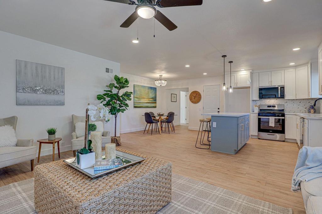 4205 Rene Drive San Diego, CA 92154 - Photo 8 of 29 a living room with furniture kitchen view and a wooden floor