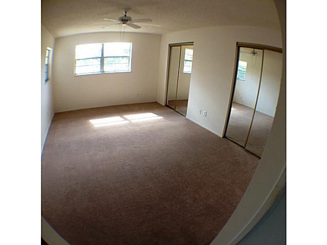 2950 Southeast Ocean Boulevard, Unit 1357 Stuart, FL 34996 - Photo 11 of 25 a view of an empty room with wooden floor and a window