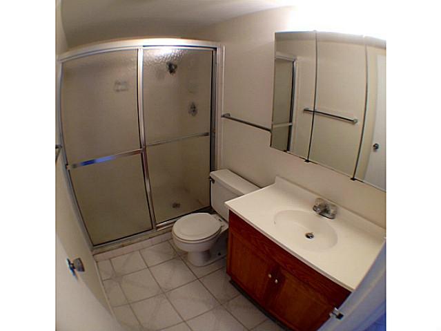 2950 Southeast Ocean Boulevard, Unit 1357 Stuart, FL 34996 - Photo 12 of 25 a bathroom with a sink toilet and shower