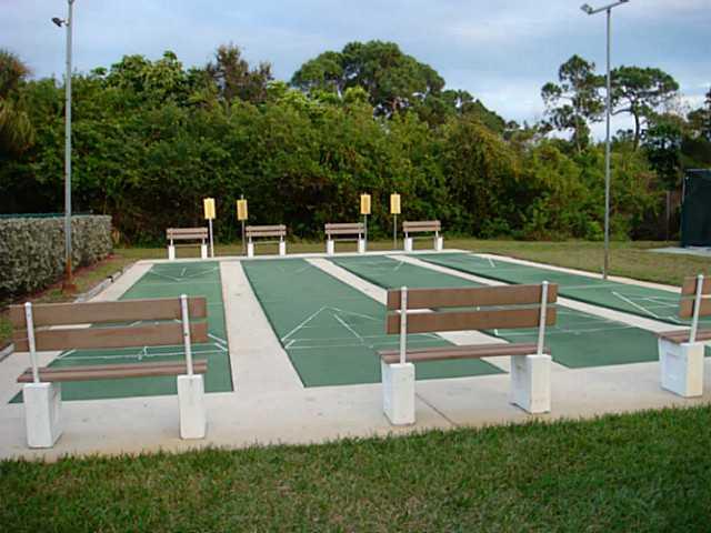 2950 Southeast Ocean Boulevard, Unit 1357 Stuart, FL 34996 - Photo 19 of 25 a view of a tennis ground with a large trees