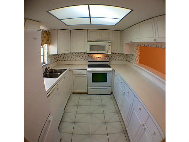 2950 Southeast Ocean Boulevard, Unit 1357 Stuart, FL 34996 - Photo 4 of 25 a kitchen with a sink a stove and cabinets