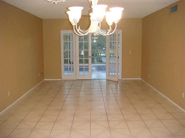 2950 Southeast Ocean Boulevard, Unit 1357 Stuart, FL 34996 - Photo 6 of 25 a view of a room with wooden floor and white walls