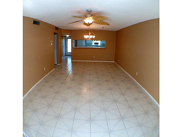 2950 Southeast Ocean Boulevard, Unit 1357 Stuart, FL 34996 - Photo 10 of 25 a view of an empty room with window and chandelier fan