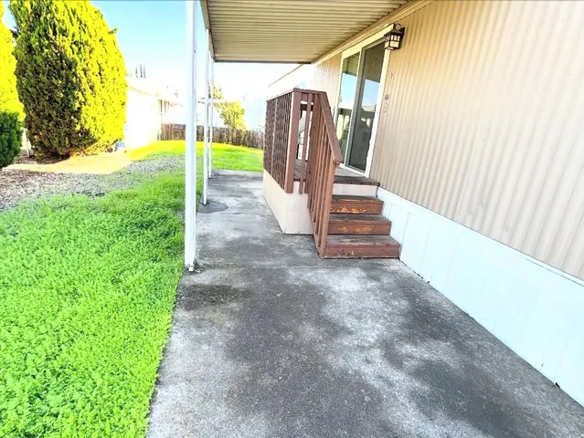 a view of a yard with wooden fence