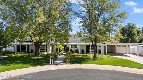 a front view of a house with a yard and porch