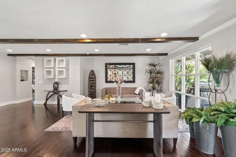 a dining room with furniture and wooden floor