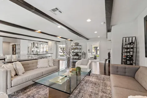 a living room with furniture and view of kitchen