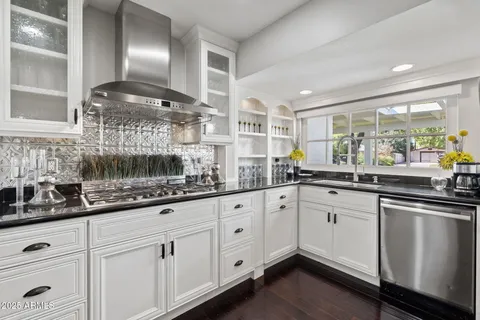 a kitchen with granite countertop cabinets and stainless steel appliances