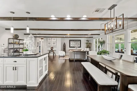 a dining table with chairs and wooden floor