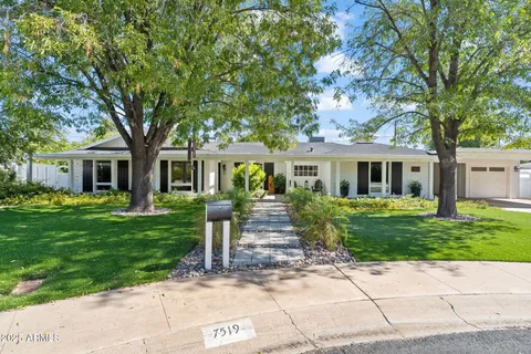 a front view of a house with a garden
