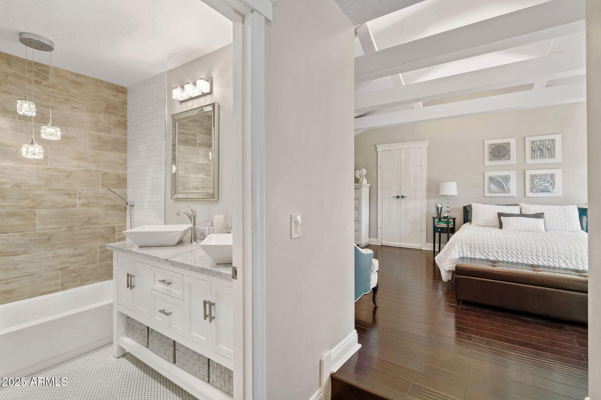 7519 North 12th Avenue Phoenix, AZ 85021 - Photo 21 of 52 a en suite bathroom with a double vanity sink a mirror and a shower