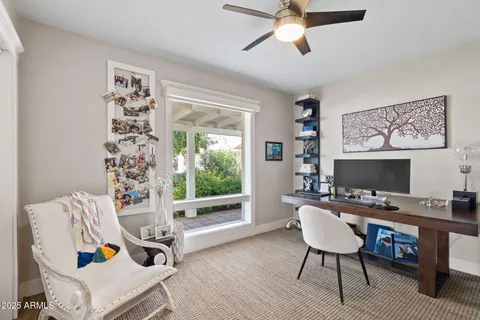 a kitchen with white cabinets and wooden floor