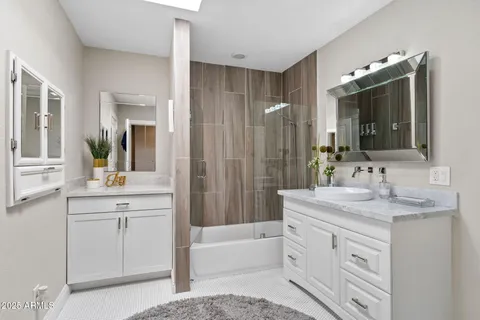 a bathroom with a granite countertop sink a toilet and a mirror