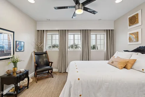 a bedroom with a large bed and a window