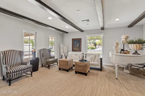 a living room with furniture a large window and potted plant